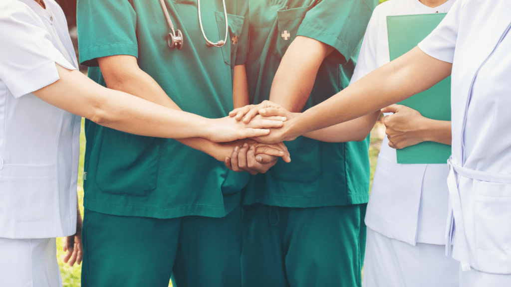 Nurses putting hands in a circle