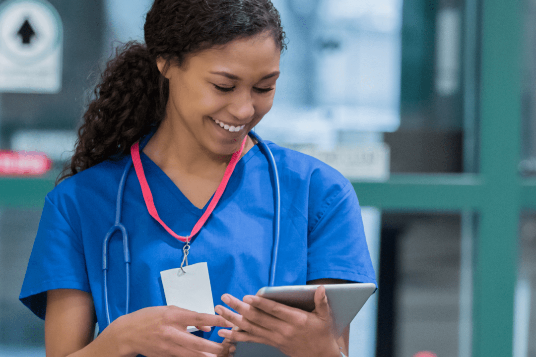 Black, female nurse using technology in nursing