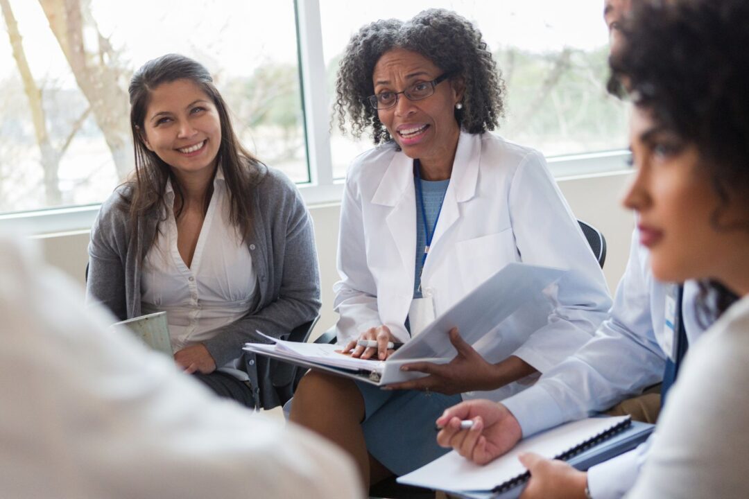 healthcare professionals sitting in a meeting